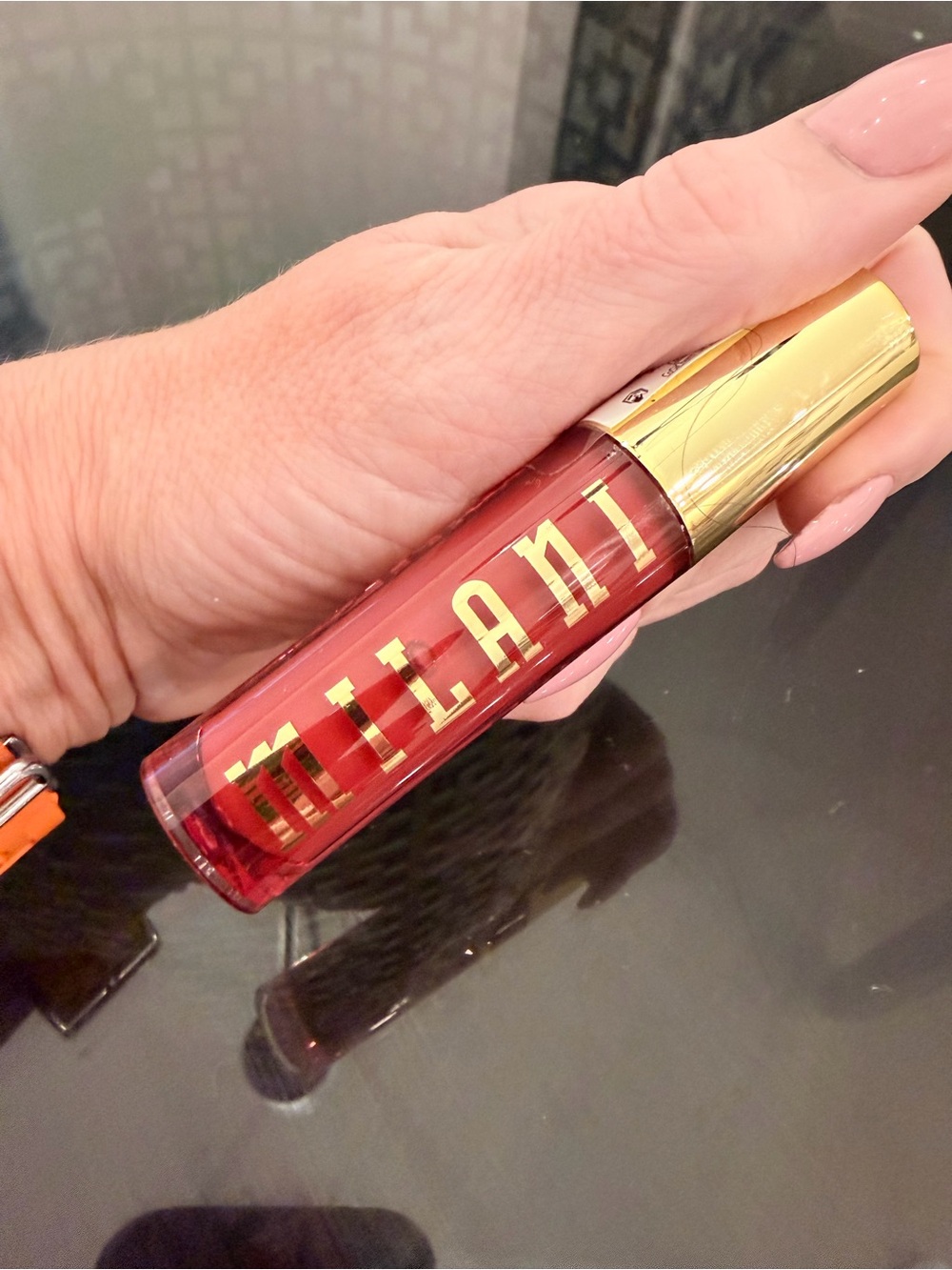 Milani Liquid lip oil in Bold lychee nectar with Gold Cap